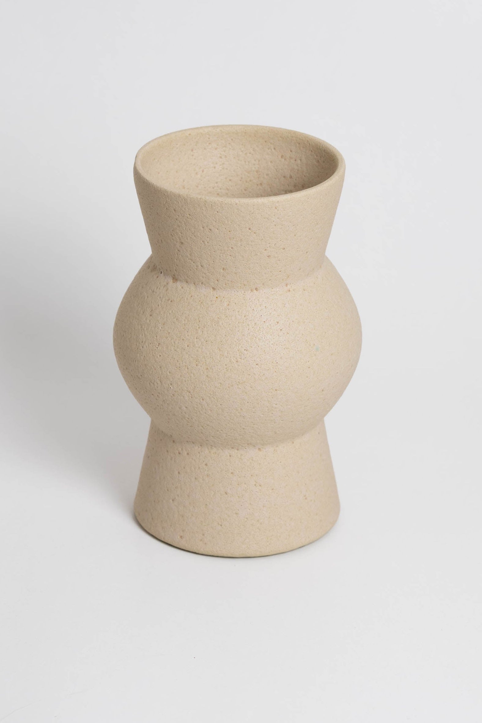 Melas in cream, ceramic vase with a textured, earthy surface, handmade in Portugal. Perfect for displaying flowers or as a unique decorative vase in modern interiors.