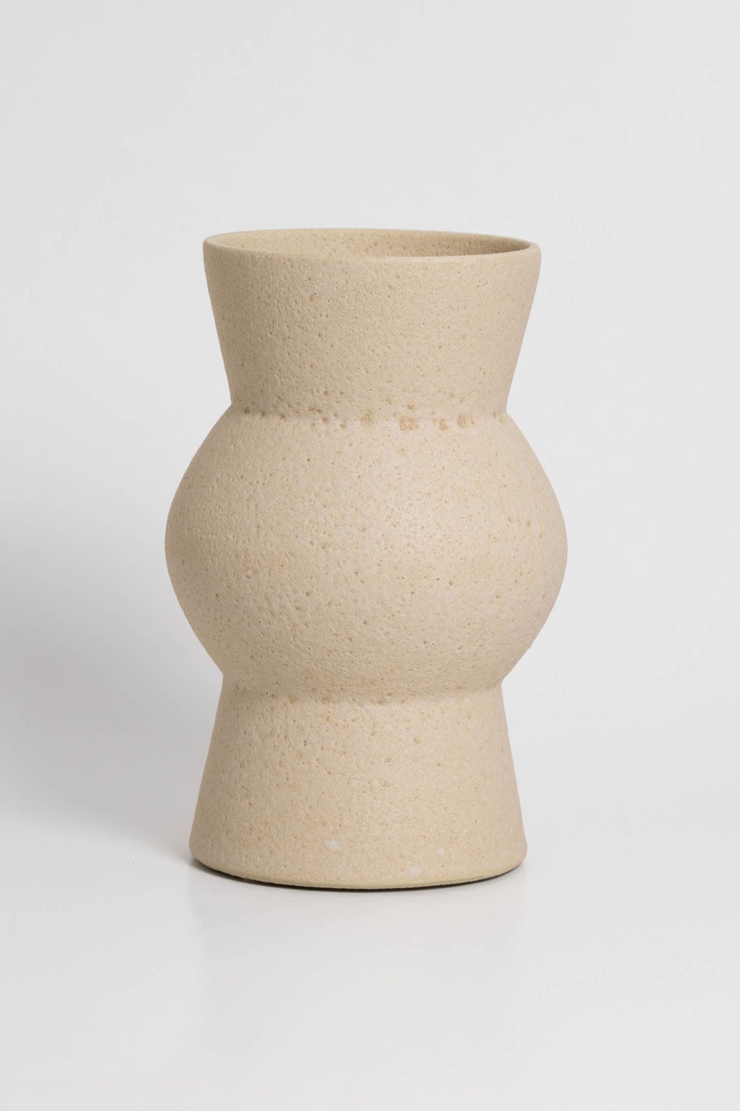 Melas in cream, ceramic vase with a textured, earthy surface, handmade in Portugal. Perfect for displaying flowers or as a unique decorative vase in modern interiors.